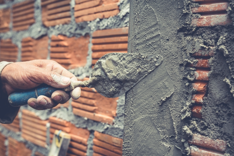 Workers are applying cement with construction additives Workers are applying cement with construction additives
